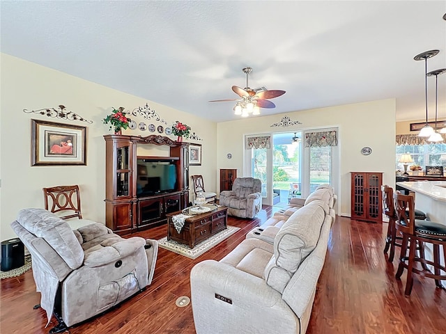 living area featuring dark wood-style floors and a ceiling fan