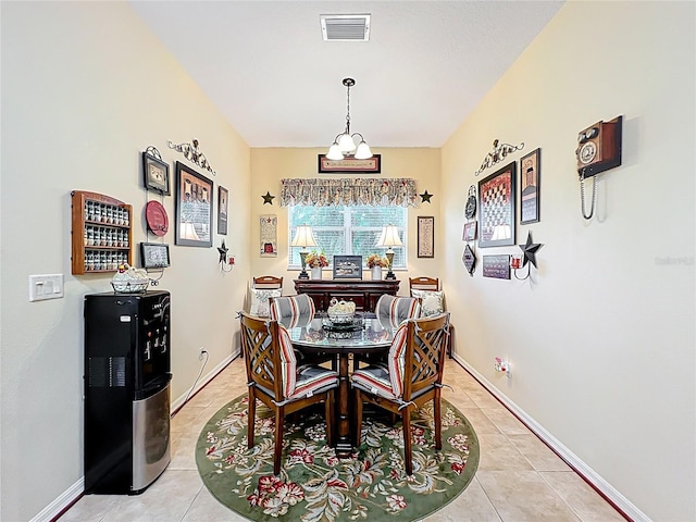 dining area featuring light tile patterned flooring, visible vents, a notable chandelier, and baseboards