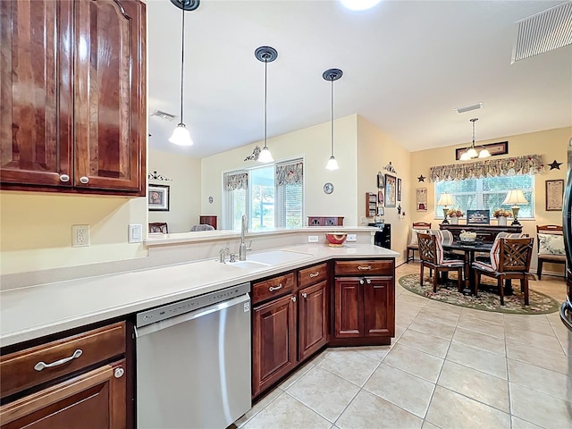 kitchen featuring a sink, visible vents, stainless steel dishwasher, and light countertops