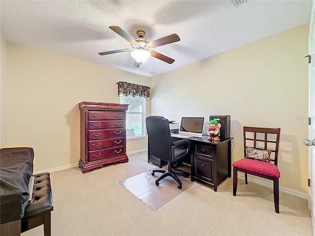 office featuring light colored carpet, baseboards, and a textured ceiling