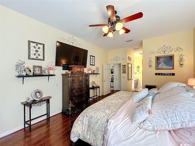 bedroom with dark wood finished floors, baseboards, and visible vents