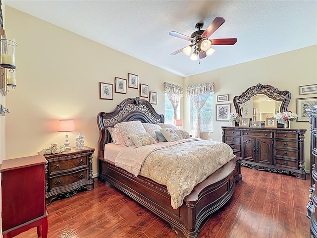 bedroom with dark wood-type flooring and a ceiling fan