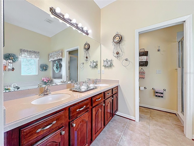 bathroom with tile patterned floors, a stall shower, visible vents, and a sink