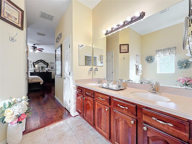 bathroom with tile patterned floors, visible vents, and a sink