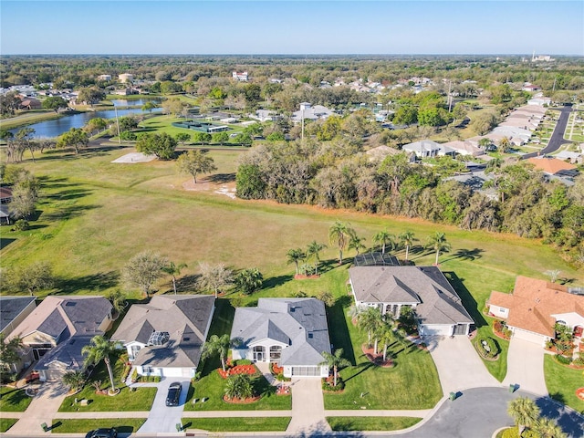 drone / aerial view with a water view and a residential view