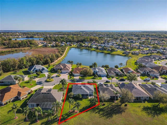 drone / aerial view with a residential view and a water view