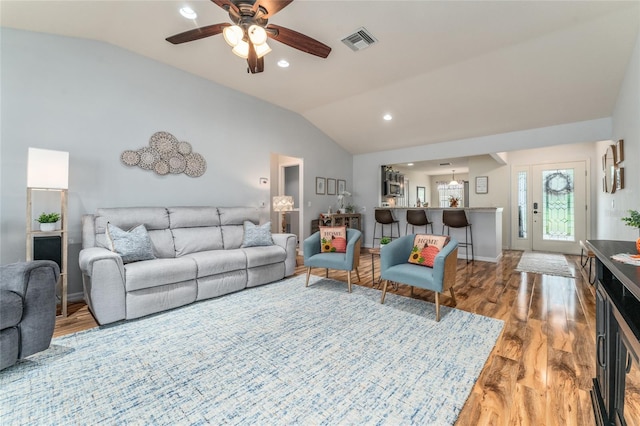 living room with visible vents, a ceiling fan, wood finished floors, recessed lighting, and vaulted ceiling