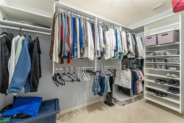 spacious closet featuring carpet and visible vents