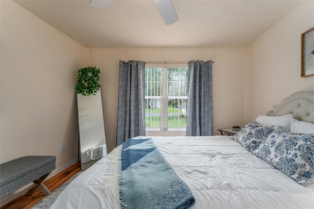 bedroom featuring baseboards, a ceiling fan, and wood finished floors