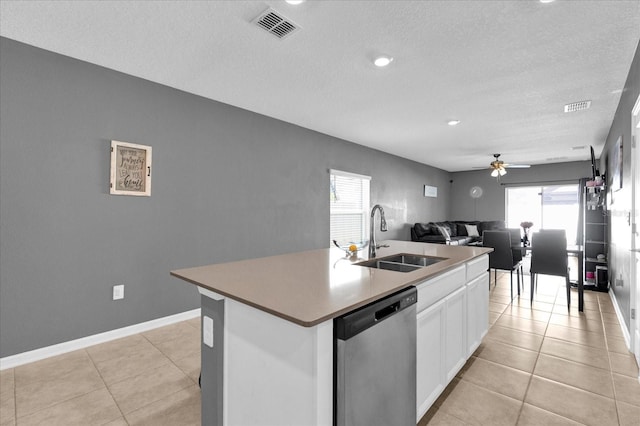 kitchen with a kitchen island with sink, a sink, visible vents, and stainless steel dishwasher