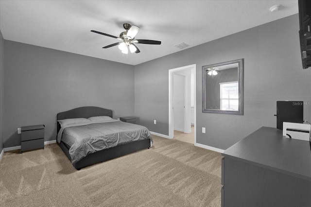 carpeted bedroom featuring visible vents, a ceiling fan, and baseboards