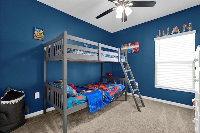 carpeted bedroom featuring baseboards and ceiling fan