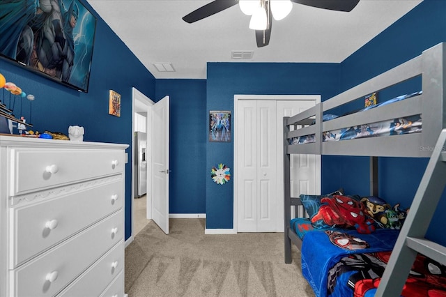 bedroom featuring visible vents, a ceiling fan, a closet, carpet floors, and baseboards