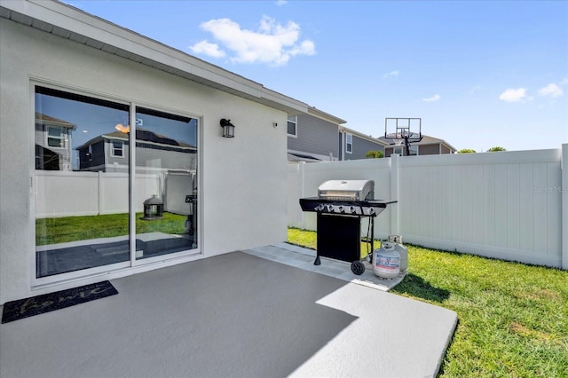 view of patio featuring fence and a grill