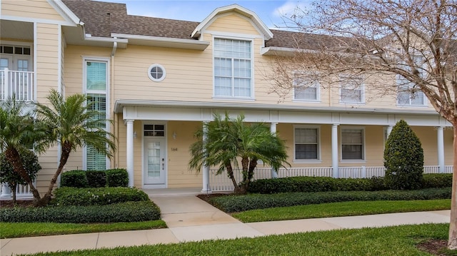 164 Nautica Mile Dr, Clermont, FL 34711 - townhome / multi-family property with covered porch and roof with shingles