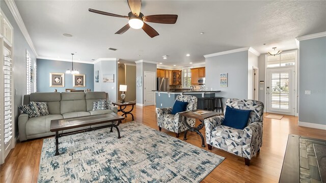 164 Nautica Mile Dr, Clermont, FL 34711 - living area featuring ornamental molding, a ceiling fan, light wood-type flooring, and baseboards