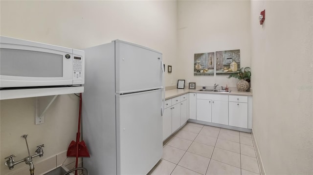 164 Nautica Mile Dr, Clermont, FL 34711 - kitchen with a sink, white cabinetry, white appliances, light countertops, and light tile patterned floors