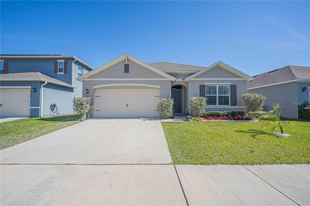 3719 Holly Grove Ln, Mount Dora, FL 32757 - view of front of home with a front lawn, driveway, a garage, and stucco siding