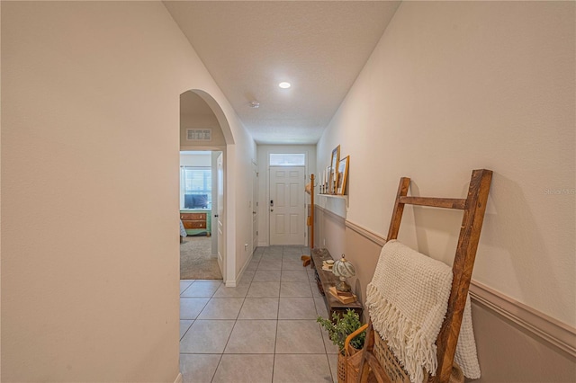 3719 Holly Grove Ln, Mount Dora, FL 32757 - hallway featuring arched walkways, light tile patterned floors, recessed lighting, and baseboards