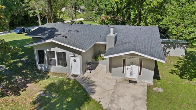 3058 SE 3rd Ave, Ocala, FL 34471 - view of front of house with stucco siding, roof with shingles, and a front lawn