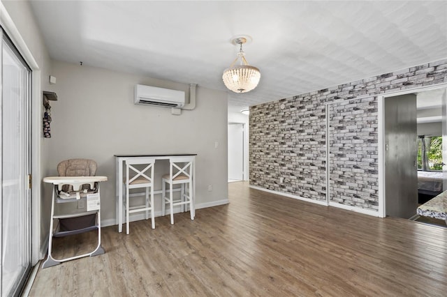 3058 SE 3rd Ave, Ocala, FL 34471 - interior space featuring wood finished floors, baseboards, brick wall, and a wall mounted AC