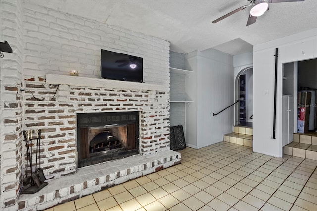 3058 SE 3rd Ave, Ocala, FL 34471 - unfurnished living room featuring a fireplace, tile patterned floors, a ceiling fan, and arched walkways