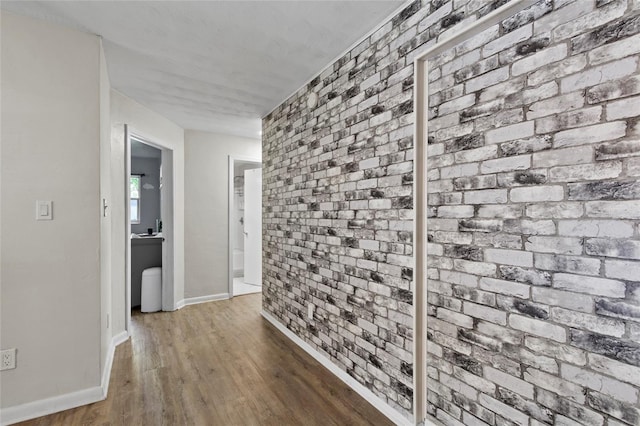 3058 SE 3rd Ave, Ocala, FL 34471 - hall featuring brick wall, baseboards, and wood finished floors