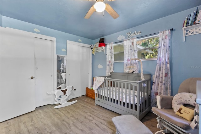 3058 SE 3rd Ave, Ocala, FL 34471 - bedroom featuring a nursery area, wood finished floors, two closets, and ceiling fan