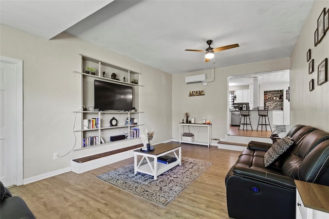 3058 SE 3rd Ave, Ocala, FL 34471 - living area with baseboards, wood finished floors, ceiling fan, and a wall mounted AC