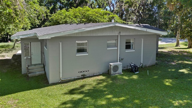 3058 SE 3rd Ave, Ocala, FL 34471 - view of side of home with concrete block siding, roof with shingles, a yard, entry steps, and ac unit