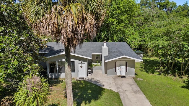 3058 SE 3rd Ave, Ocala, FL 34471 - view of front of home featuring a shingled roof, a front yard, concrete driveway, and stucco siding