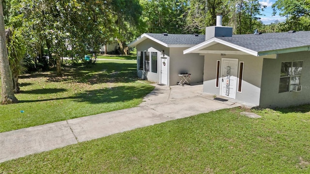 3058 SE 3rd Ave, Ocala, FL 34471 - exterior space featuring a lawn, a chimney, roof with shingles, and stucco siding