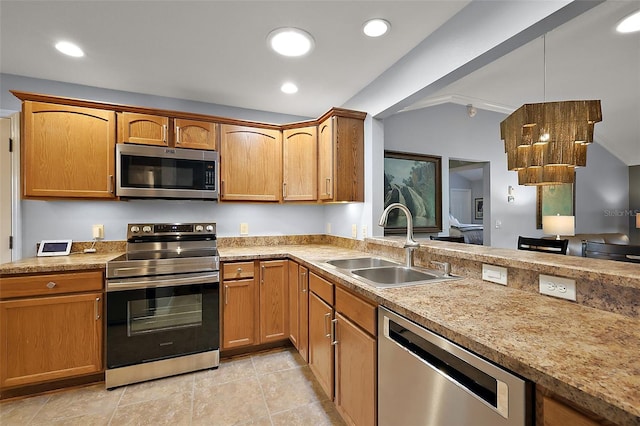 kitchen featuring lofted ceiling, recessed lighting, a sink, stainless steel appliances, and light countertops