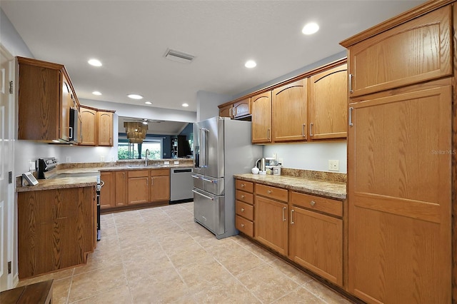 kitchen featuring a sink, brown cabinetry, recessed lighting, and stainless steel appliances