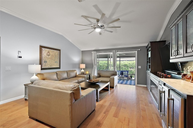 living area featuring light wood finished floors, ceiling fan, crown molding, and lofted ceiling