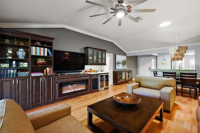 living room featuring wine cooler, visible vents, crown molding, and vaulted ceiling