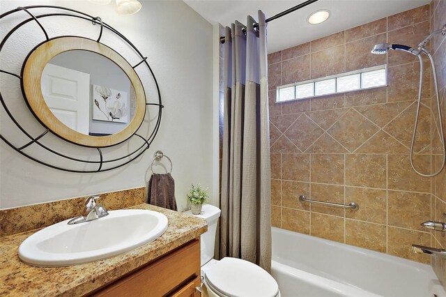 bathroom featuring recessed lighting, toilet, shower / bath combo, and vanity