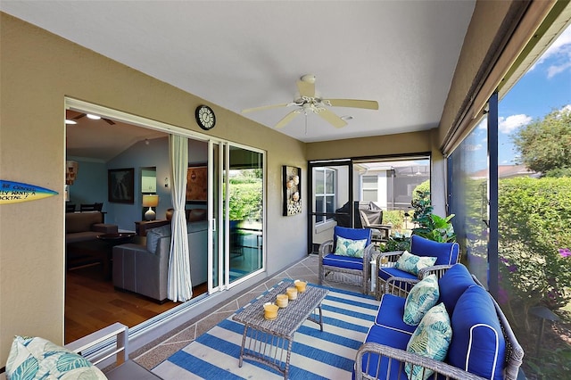 sunroom / solarium featuring lofted ceiling and a ceiling fan