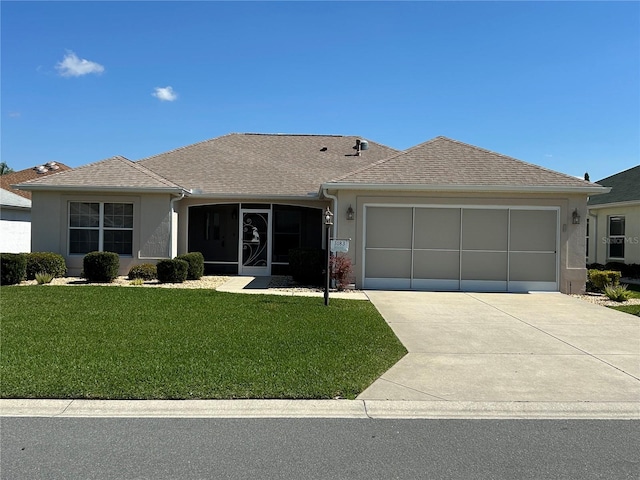 ranch-style home featuring a front lawn, roof with shingles, stucco siding, a garage, and driveway