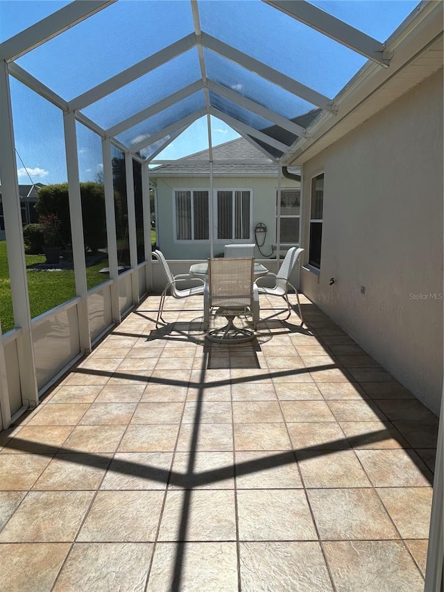 unfurnished sunroom with lofted ceiling