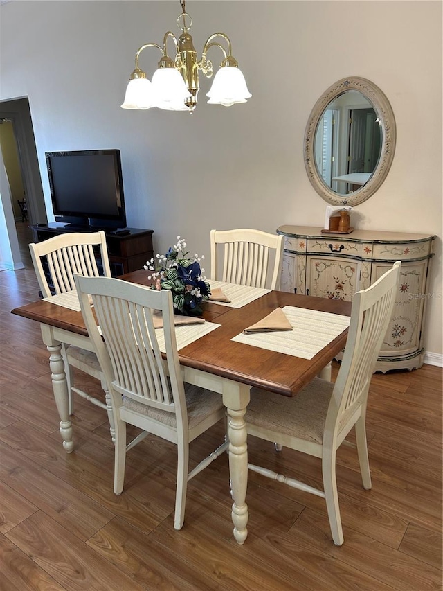 dining room with an inviting chandelier and wood finished floors