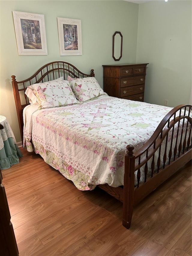 bedroom featuring wood finished floors