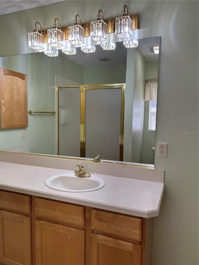 full bathroom featuring a stall shower and vanity