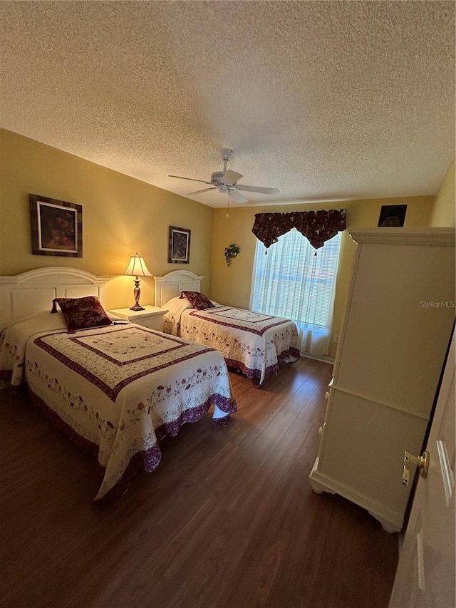 bedroom with ceiling fan, a textured ceiling, and wood finished floors