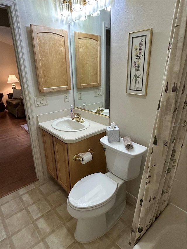 full bath featuring tile patterned floors, toilet, and vanity