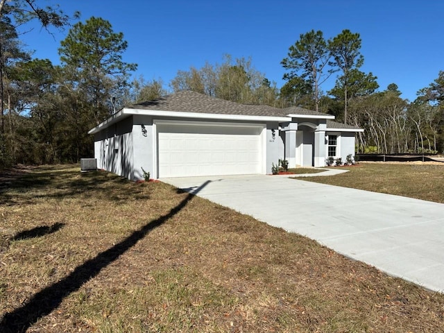 view of front of property with a front yard, central AC unit, stucco siding, driveway, and an attached garage