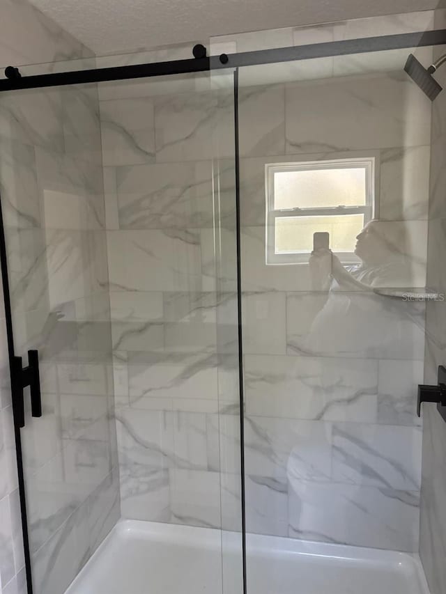 full bathroom featuring a shower stall