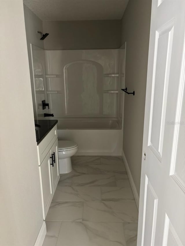 bathroom with toilet, marble finish floor, tub / shower combination, baseboards, and vanity