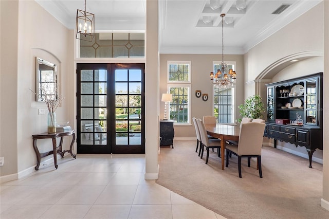 dining area featuring visible vents, crown molding, a chandelier, light colored carpet, and french doors