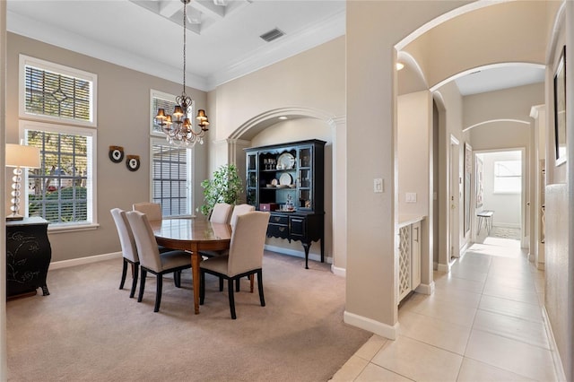 dining area featuring a chandelier, light colored carpet, light tile patterned floors, a high ceiling, and arched walkways